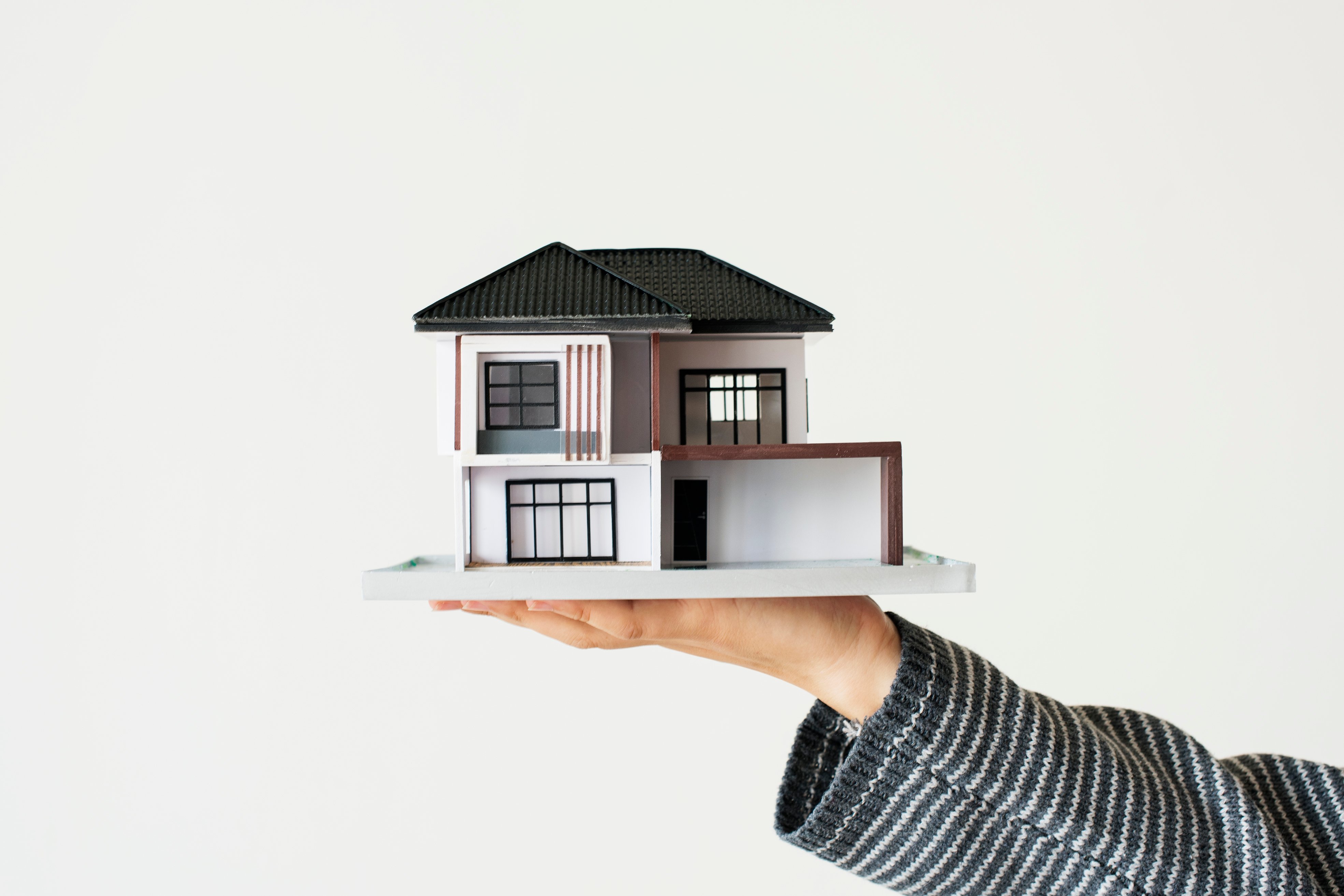 hand-presenting-model-house-for-home-loan-campaign